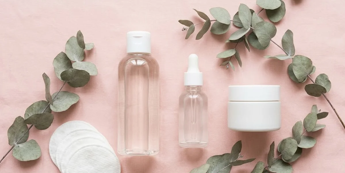 Routine skincare per acne ormonale con prodotti su superficie chiara e ingredienti attivi visibili