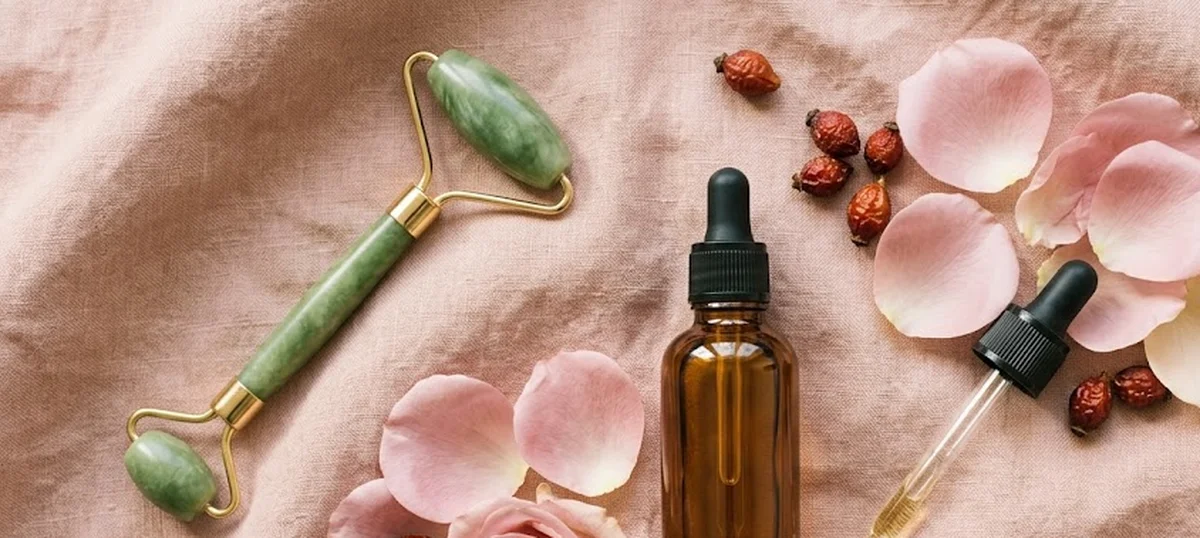 Siero trattamento cicatrici post-acne su pelle lenita con fiori di camomilla e cotton pad